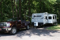 color photo of maroon pick up truck parked in front of white trailer color photo of maroon pick up truck parked in front of white trailer