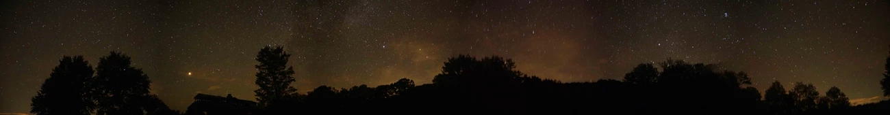 The night sky as seen from Tyler Bend View of the night sky from Tyler Bend. Black silhouette of trees below a star studded night sky.