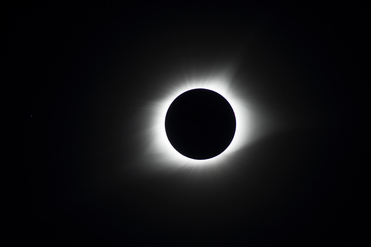 A bight ring of the sun shows around the moon during a total solar eclipse.