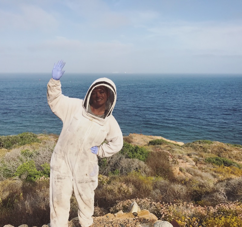 Hilary waves on the cliffs in her bee suit Hilary waves on the cliffs in her bee suit