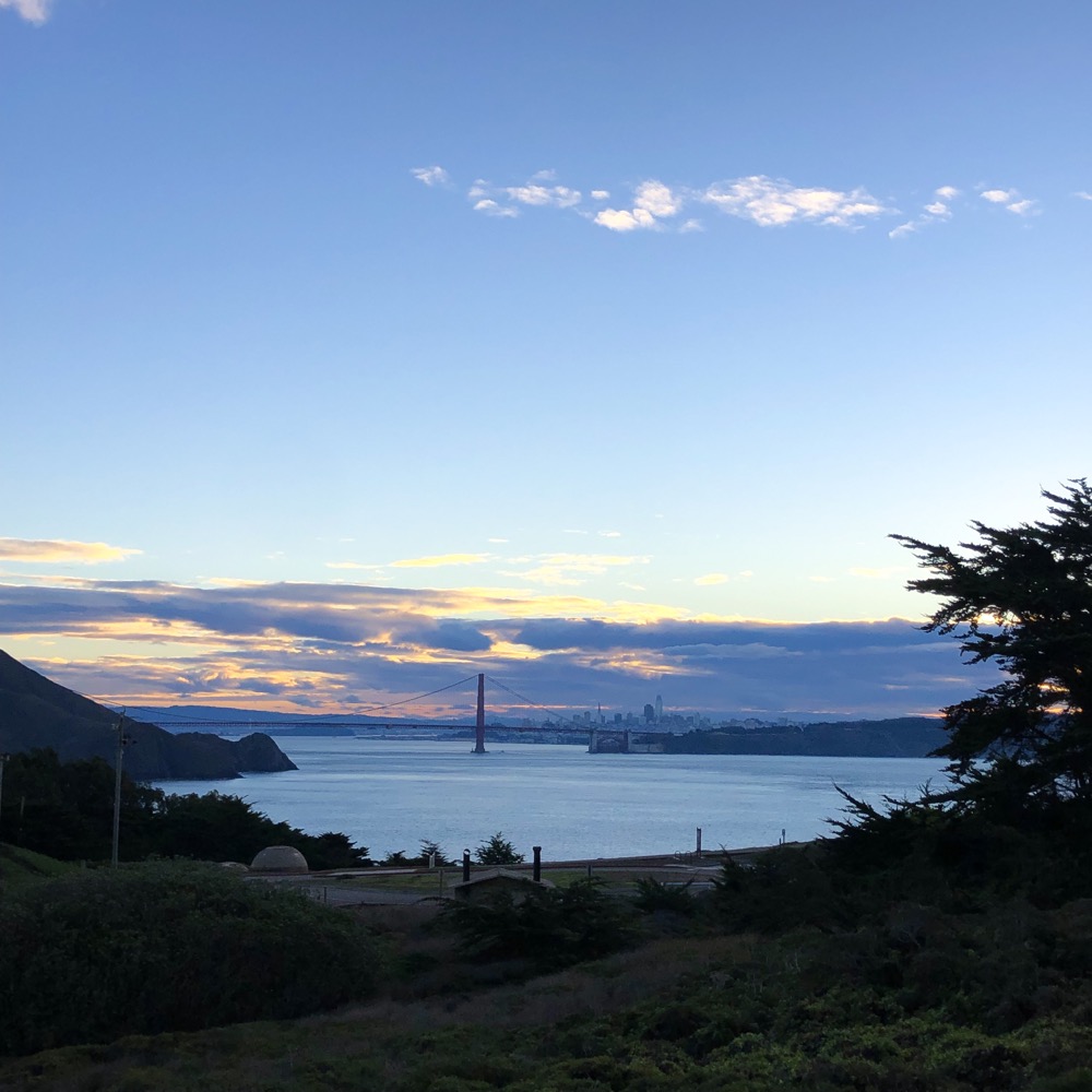 Looking East at sunrise from the Marin Headlands toward San Francisco with the Golden Gate Bridge in the middle of the picture.