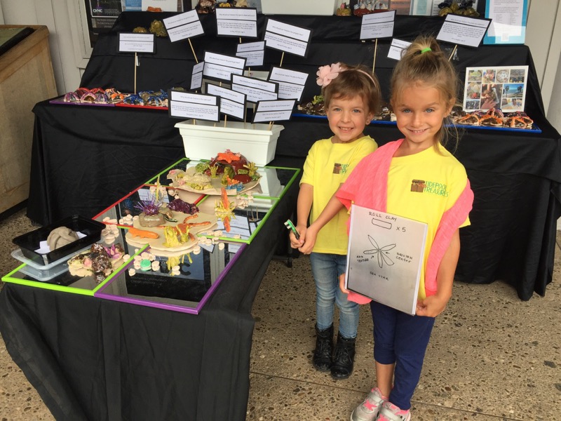 Elementary students showing off their tidepool treasures