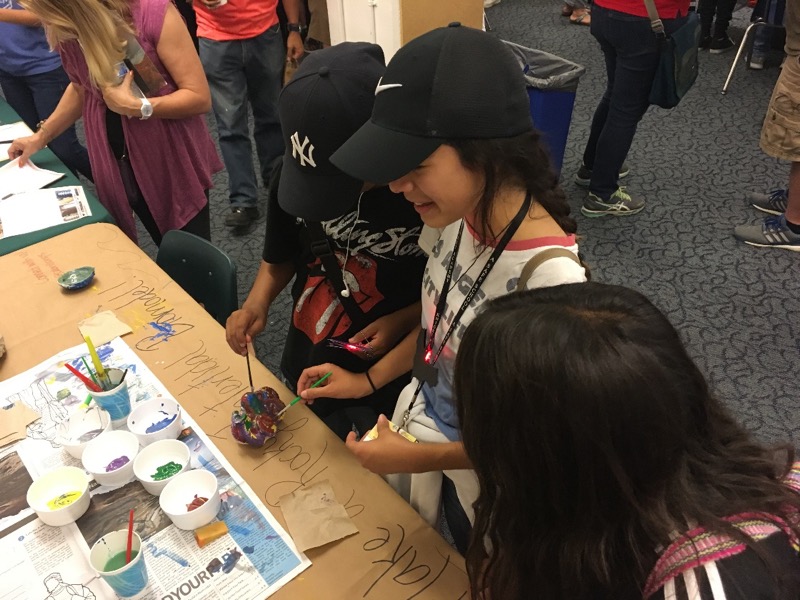 Students painting 3D models at the MakerFaire