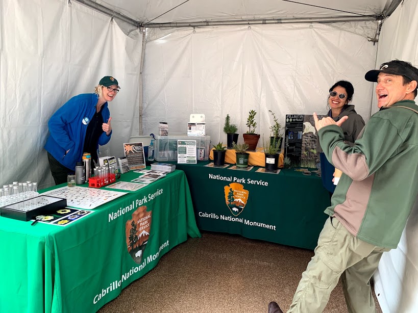 The science education and outreach team poses at their booth during the Science and Engineering Festival, complete with live plants, activities, and promotional materials. The science education and outreach team poses at their booth during the Science and Engineering Festival, complete with live plants, activities, and promotional materials.