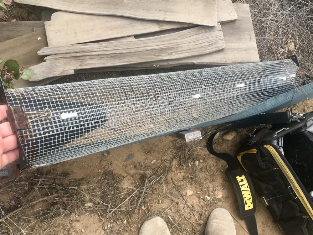 This tube made of chicken wire with cones clipped to the ends traps snakes humanely inside This tube made of chicken wire with cones clipped to the ends traps snakes humanely inside