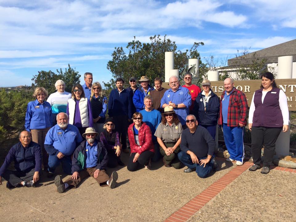 a group of people smiling for the camera near the Visitor Center at Cabrillo National Monument. a group of people smiling for the camera near the Visitor Center at Cabrillo National Monument.