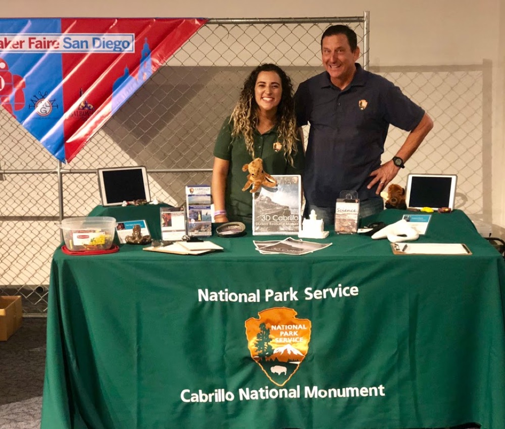 Two Cabrillo Science Education team members smiling for the camera at an exhibit table at the San Diego Maker Faire. Two Cabrillo Science Education team members smiling for the camera at an exhibit table at the San Diego Maker Faire.