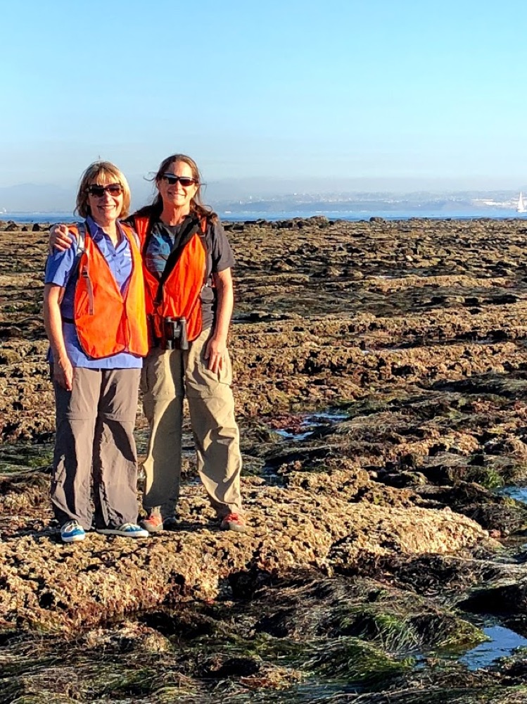 Two volunteers smiling for the camera in the tidepools at Cabrillo National Monument. Two volunteers smiling for the camera in the tidepools at Cabrillo National Monument.