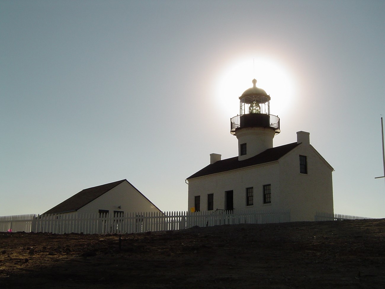 Old Point Loma Lighthouse with sun behind