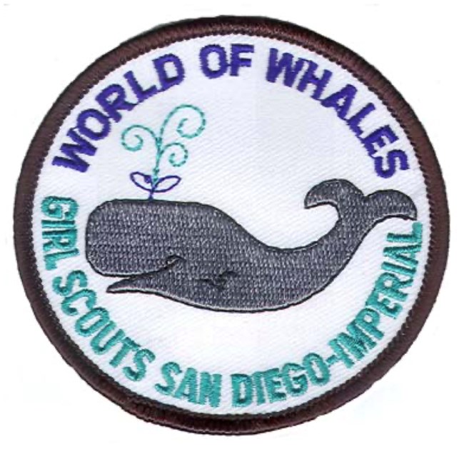 A circle patch with a black border. A gray whale is in the middle. Text above the whale says World of Whales. Text below the whale says Girl Scouts San Diego-Imperial