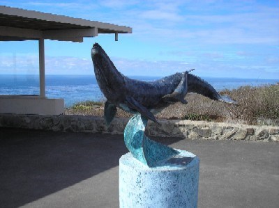 A sculpture of a sea lion on a pedestal.