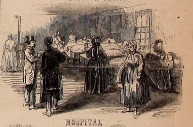 A group of people standing next to a hospital bed