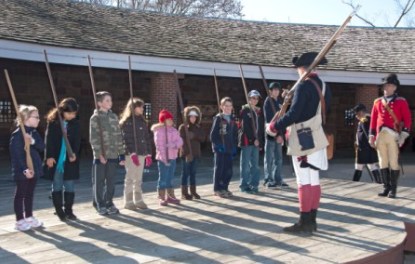Children take part in musket drill.