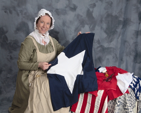 Actress Kim Hanley, shown here wearing a dress in the style of the War of 1812 era, portrays Mary Pickersgill, who created the immense flag that flew over Fort McHenry during the British attack on Baltimore in 1814.