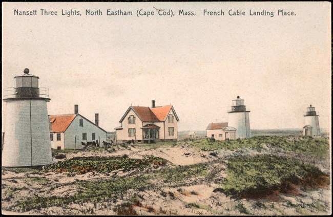 Photo shows a postcard depicting a coast with three lighthouses.