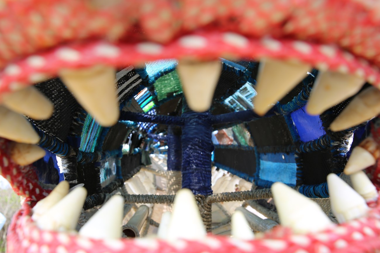 The inside of the shark's mouth reveals all the marine debris elements that make up the sculpture.