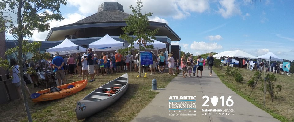 Visitors crowd Science Street Fair exhibits at the Atlantic Research and Learning Center at Cape Cod National Seashore's Centennial event. Visitors crowd Science Street Fair exhibits at the Atlantic Research and Learning Center at Cape Cod National Seashore's Centennial event.