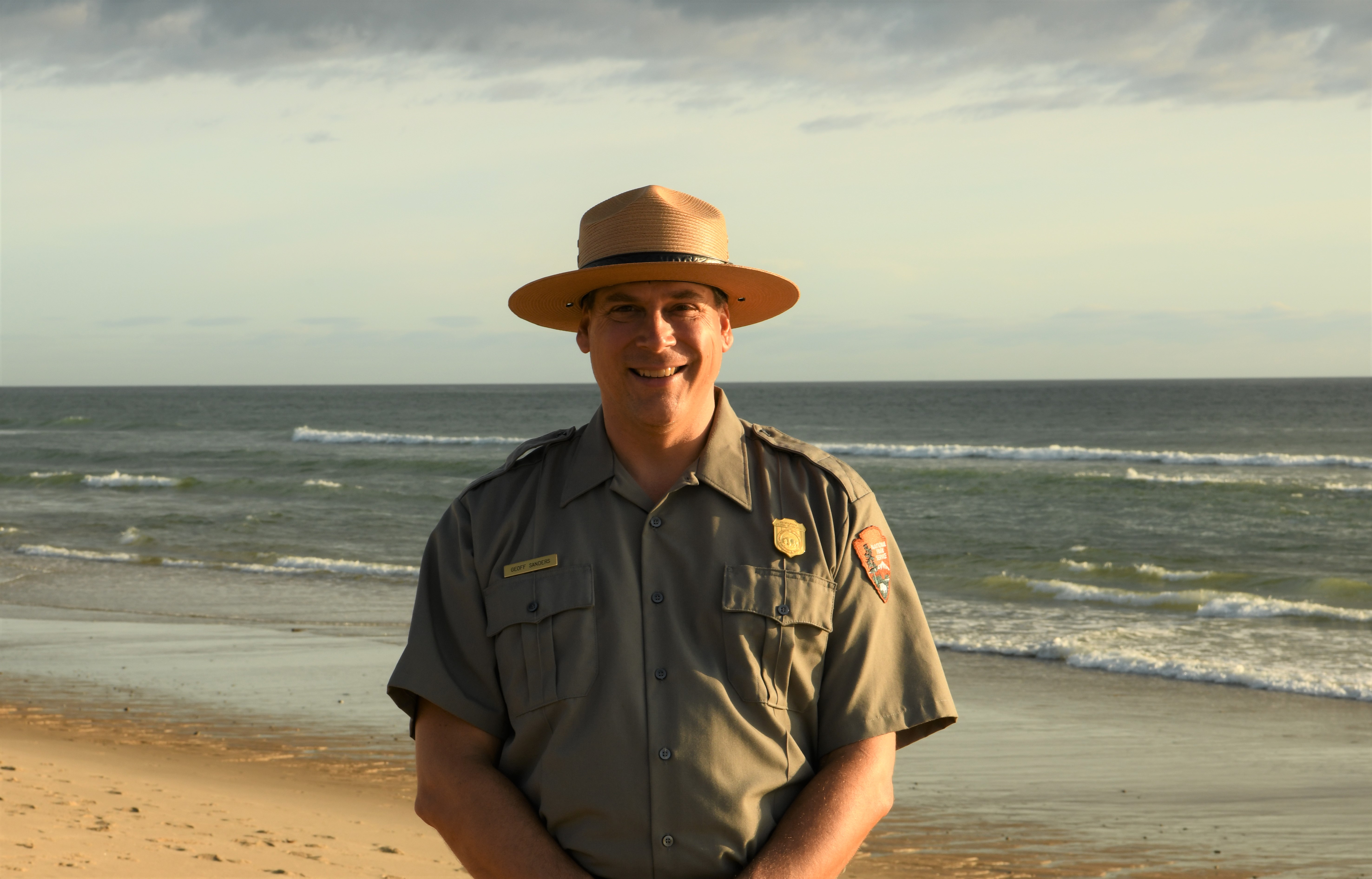Geoff Sanders Chief of Natural Resource and Science 2019 A ranger stands at the seashore