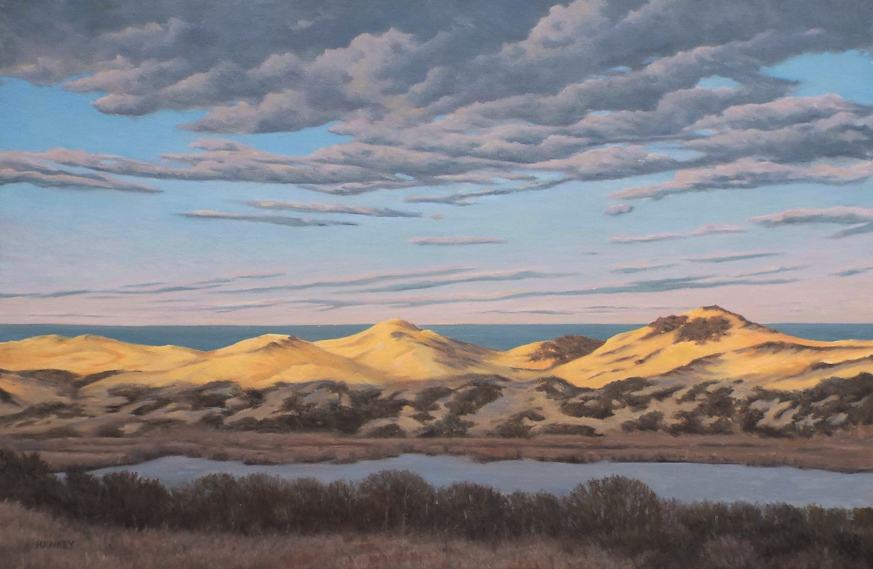 A painting of a lake rising into tall sand dunes under a cloudy sky.