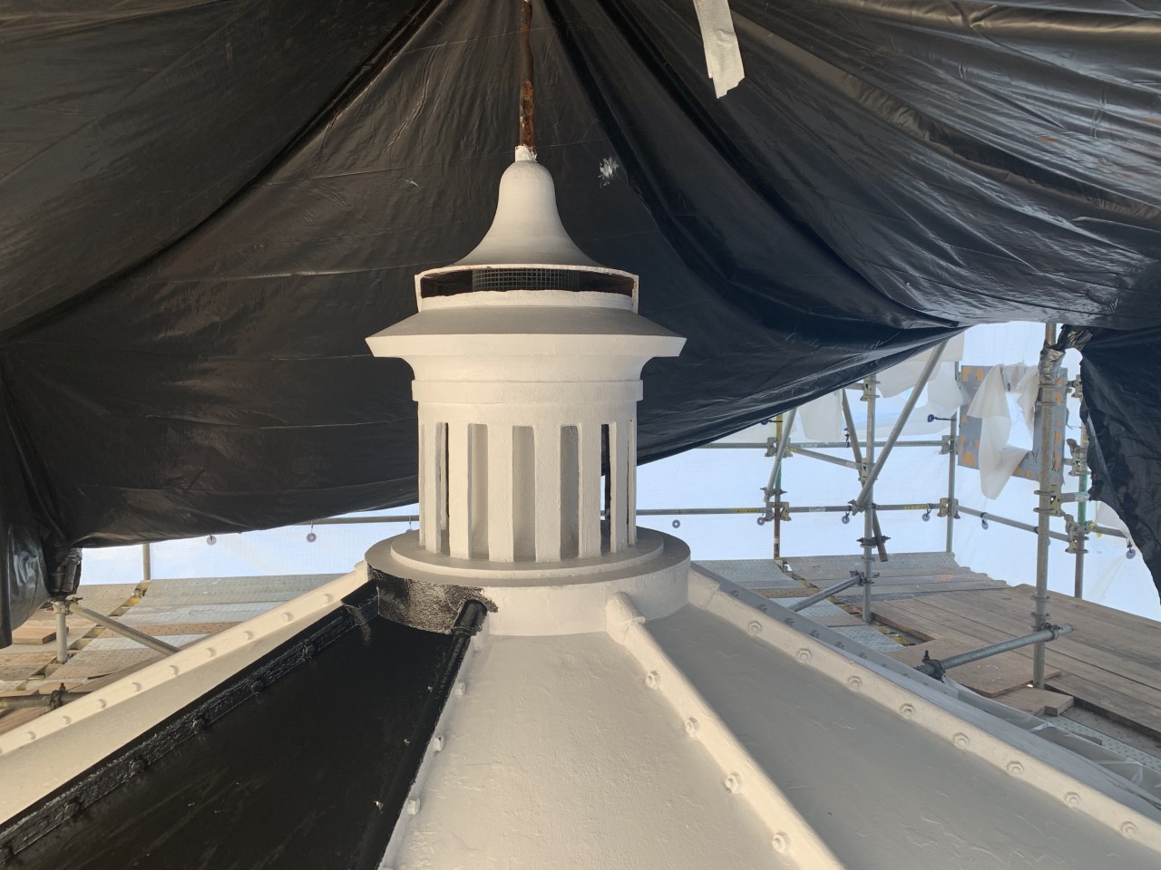 Highland Light Rehabilitation Image of the top of Highland Light with a tarp over it to show construction repairs.