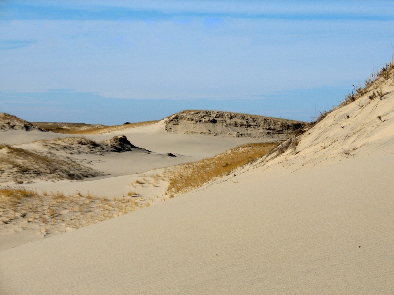 View of sandy dunes and blue sky
