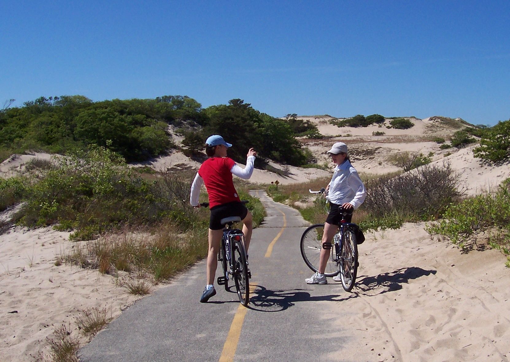 PL Bike Trail photo Two female bicyclists on narrow trail through dunes