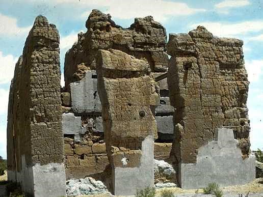 Hand colored lantern slide of the ruins with contrast between grey cement and brown caliche very visiable