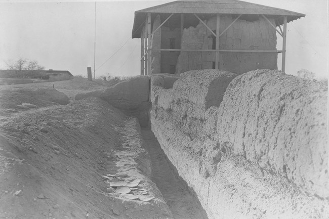 Black and White pictures of the covered Great House with trenches dug below original walls