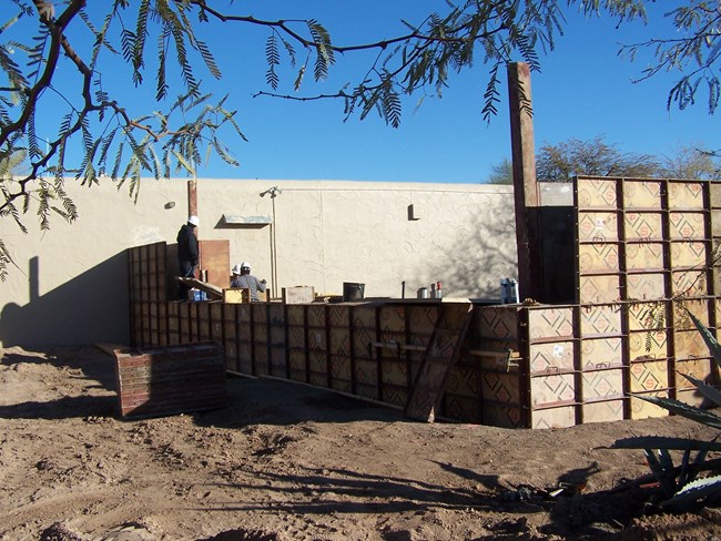 rammed earth construction with wooden frame at different levels