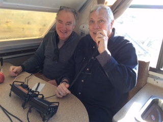 two ham radio operators using table top radio