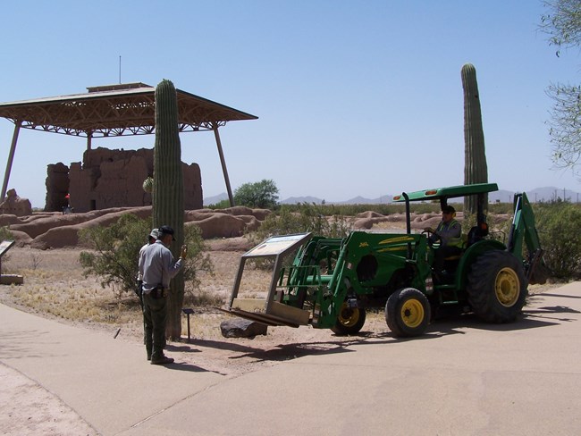 wayside sign installation in progress with backhoe