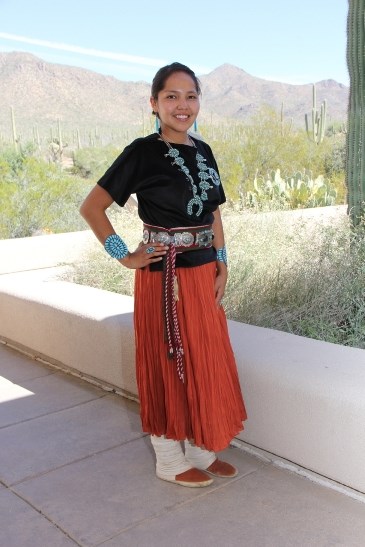 Krishel Augustine wears her fine Navajo jewelry while standing on a desert patio