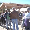 visitors listening to a talk at the outdoor ramada