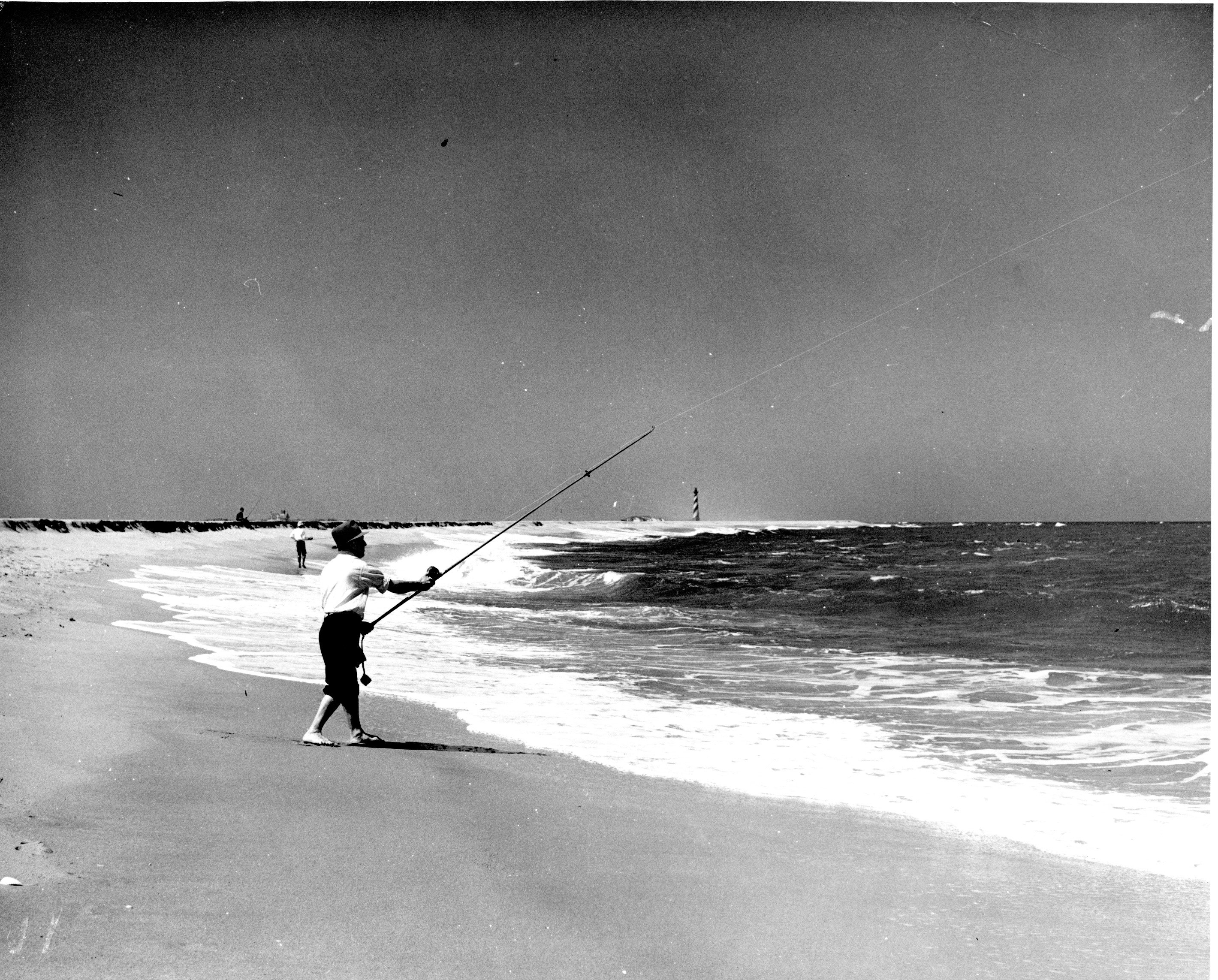 Surf fishing south of Cape Hatteras Lighthouse, 1952 Male surf angler south of Cape Hatteras Lighthouse in 1952.