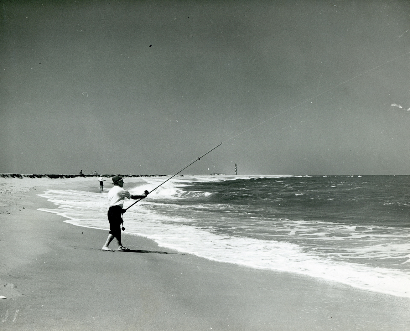 Cape Hatteras surf fishing with lighthouse in background. Cape Hatteras surf fishing with lighthouse in background.