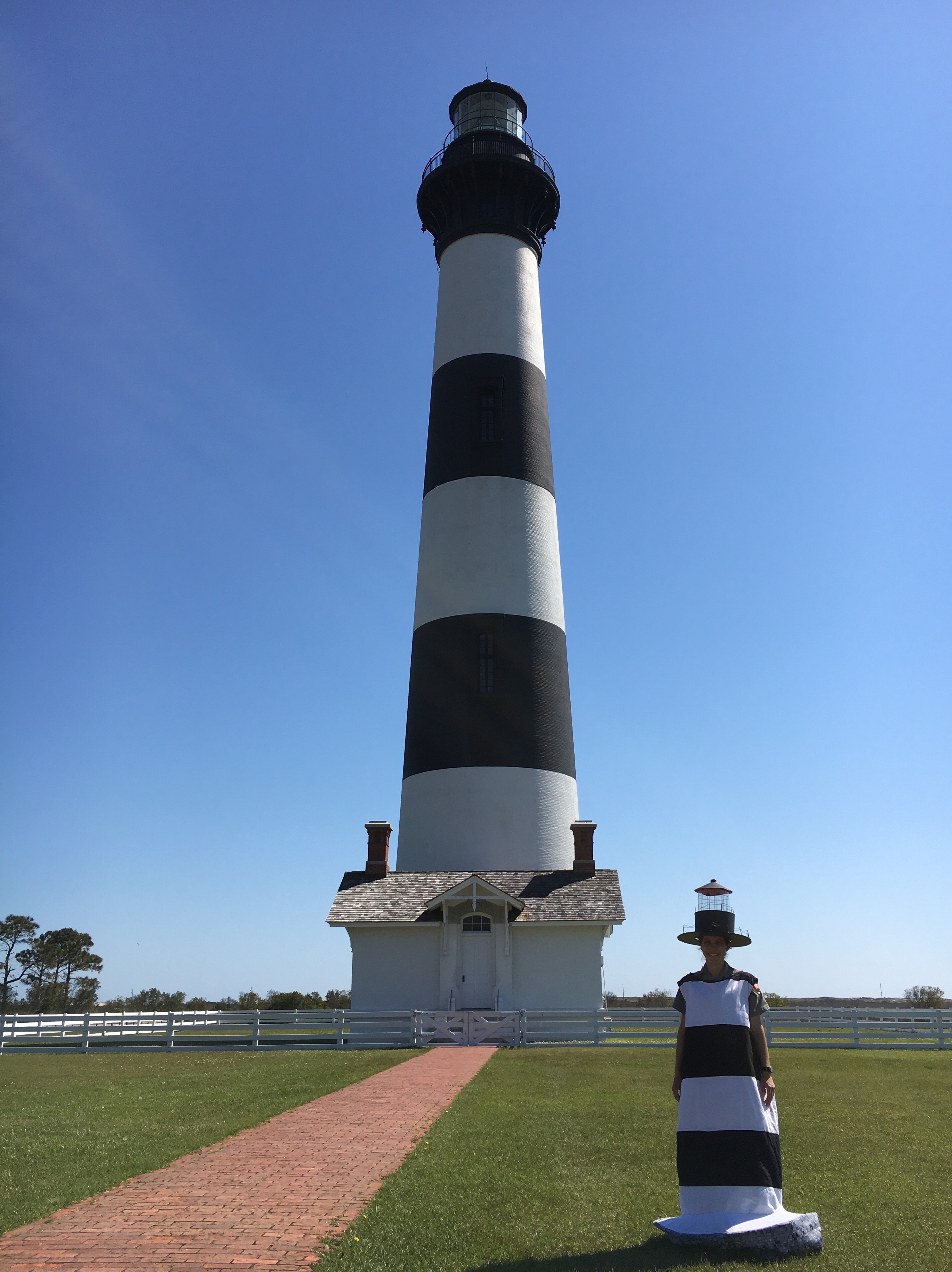 A photo of a park ranger dressed like the Bodie Island Lighthouse on National Look Alike Day.