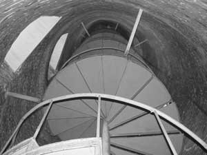 A view inside the Ocracoke Lighthouse shows the stairs spiraling their way to the top.