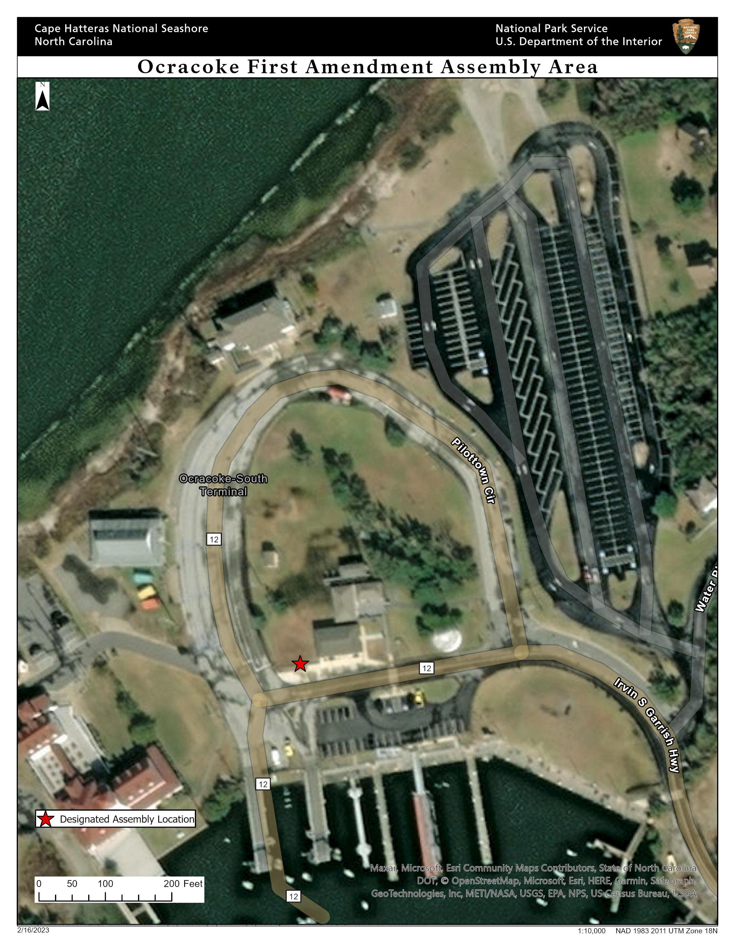Aerial photograph of numerous roads and docks. The designated assembly location lies in the south-central part of the map across a road from docks.