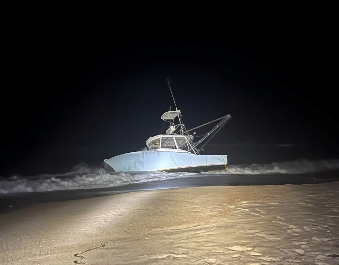 Powder blue grounded vessel during nighttime hours.