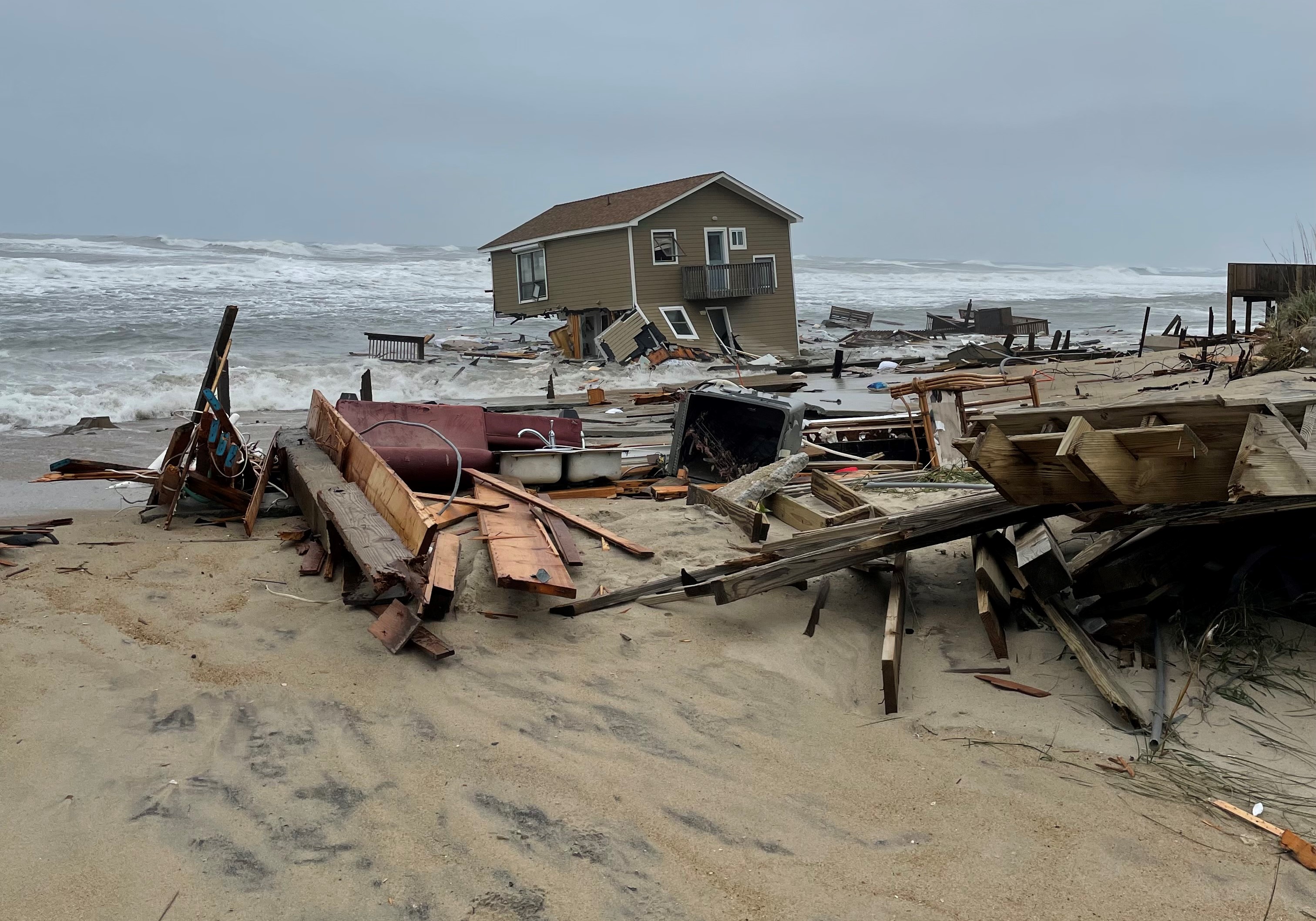 Collapsed house at 24265 Ocean Dr, Rodanthe, NC 05-10-2022 Tan collapsed house in Rodanthe, N.C.