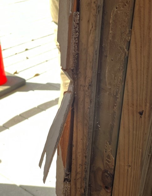 Photo of restroom door frame damage caused by the door being kicked in.
