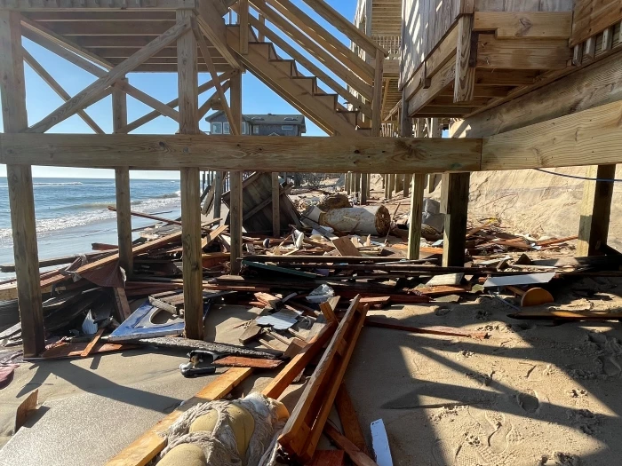 Debris from collapsed house extends beneath nearby homes 02-10-2022 Debris underneath homes near collapsed house site.
