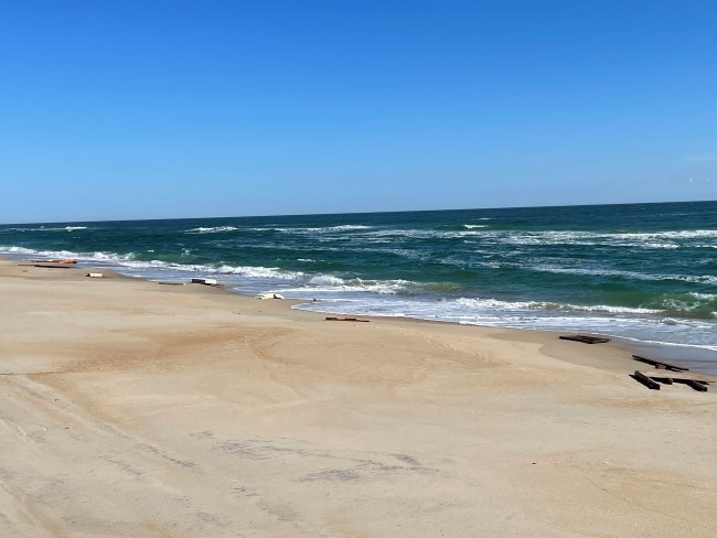 Debris on beach near ocean.