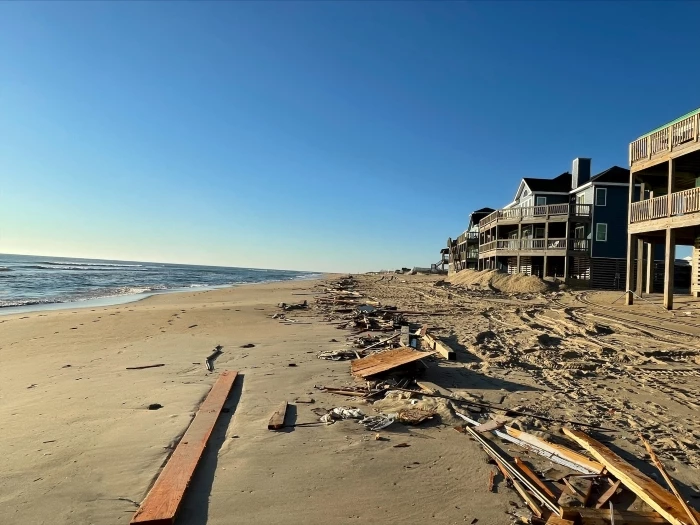 Field of debris south of collapsed house site 02-10-2022 Debris from collapsed house stretching across length of beach.