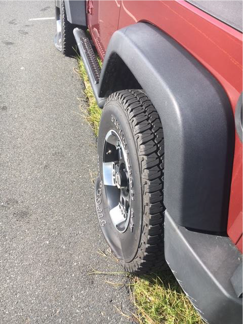 Slashed rear tire on a Jeep Wrangler Slashed rear tire on a red Jeep Wrangler.