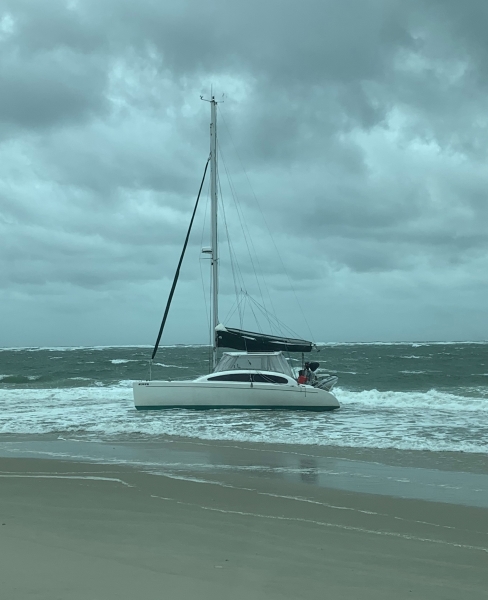 Sailing Vessel Katalyst sits grounded on beach north of Oregon Inlet. A sailing vessel sits on beach.