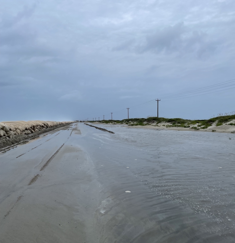 North end of Ocracoke Island. Photo showing ocean overwash on highway near north end of Ocracoke Island.