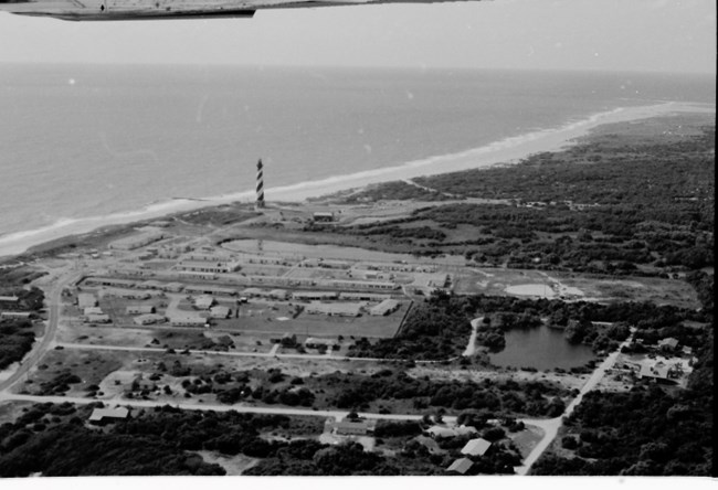 Black and white aerial view of Coast Guard Station and the Cape Hatteras Lighthouse.