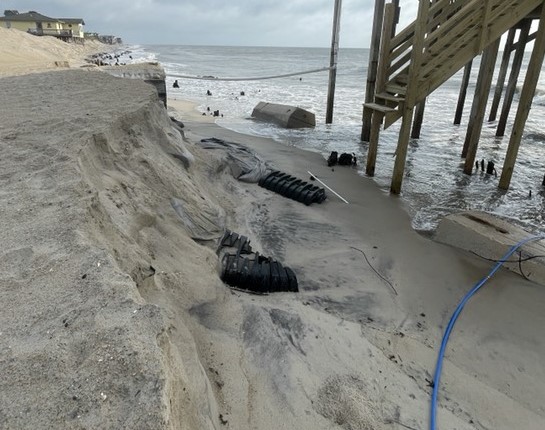 Photo of hazards on the beach adjacent to G.A. Kohler Court, Rodanthe. Photo showing erosion and hazards on the beach next to houses.