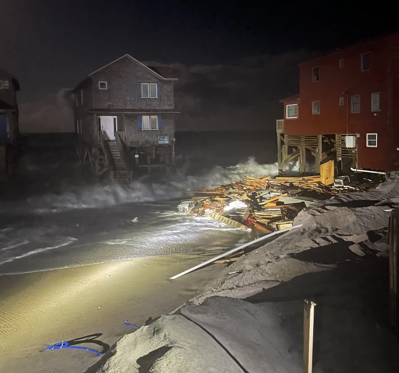 Photo taken the night of September 20 shows debris from 23009 G A Kohler Court at the south end of G A Kohler Court. Nighttime photo of debris on the beach near houses.